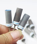 Hand holding 10 Pcs Mixed Grit Sandpaper Drum Set For Dremel Rotary Tools 1 Eighth Inch Shank Abrasive Sanding Sleeve Rolls