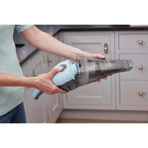 Person using Cordless Handheld Vacuum Cleaner For Home And Car With Crevice Attachment, showing translucent dirt bowl.