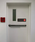 Heavy Duty Acrylic Restricted Area Sign For Authorized Personnel Only Doors on white door with window.
