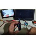 Hands adjusting Beefed-Up 5.8 Gigahertz 2000mW FPV Transmitter For Drones With 20km Range 8-Channel Video TX With 5dBi SMA Antenna