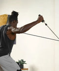 Top Tier Space Saving Home Gym Resistance Band System With Gliding Wall Track Three Foot Aluminum Mount And Five Bands Plus Handles in use.