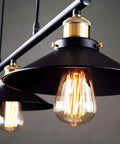 Fresh Vintage Industrial Billiard Chandelier Features Easily Adjustable Pulley Lift System In Classic Black Metal Three Light Ceiling Hanging Lamp detail with exposed bulb and black shade.
