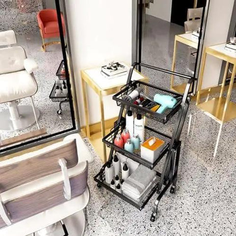 Heavy Duty Metal Rolling Storage Cart With Smooth Rolling Wheels For Kitchen Bathroom Laundry And Office Folding Utility Shelf filled with beauty products in a stylish salon.