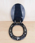 Top Shelf Black Resin Toilet Seat Universal Fit Easy Clean Bathroom Lid with decorative speckled design and stainless hinges.