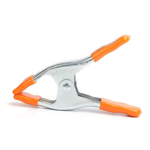 2 Inch Spring Clamp With Handle One Handed Clamping Tool Silver Orange Finish Quick Release Paddle Action for Woodworking and DIY Projects Workhorse Grip Control angled view