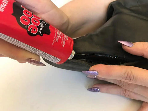 Applying Do It All Shoe Adhesive And Sealant, 3.7 Fl Oz, Waterproof Black For Boots And Shoes to repair a black shoe sole.