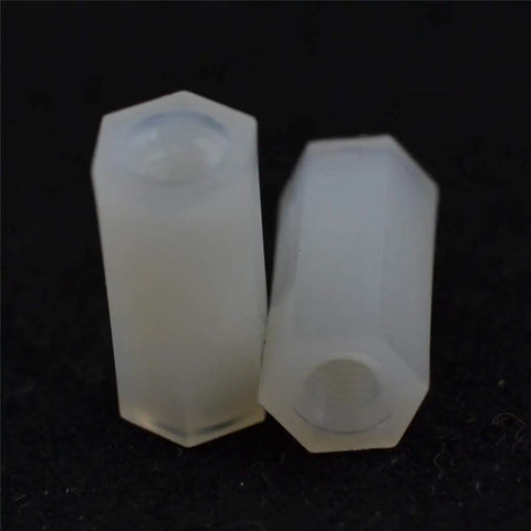 Real Deal White Nylon Hex Standoff 100 Pack M3x12mm Dual Ended Spacers Built Tough For Electronics Projects close-up view of two hex nylon standoffs.