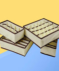 Top Tier Nonwoven Bra And Underwear Storage Boxes Four Piece Set ideal for closet organization, soft beige material with brown trim.