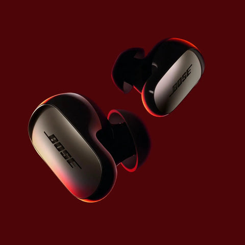 QuietComfort Ultra Earbuds 2nd Gen Dope Wireless Noise Canceling With Built In Microphone Immersive Audio USB C Charging Up To Six Hours Battery Life IPX4 Rating Black, shown on a maroon background.