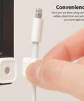 Hand attaching cable to Magnetic Cable Clips 3 Pack For Car And Office Cable Management Self Adhesive Cable Organizer Clips Black