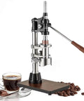 Manual Leverage Espresso Coffee Maker With 16 Bar Hand Pressure Pump Built From Tough 304 Stainless Steel on wooden base with coffee.