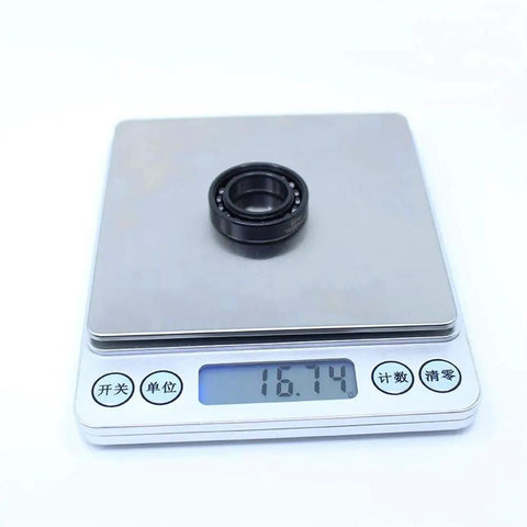 Rock Solid 2Pc High Temp Thin Section Bearings 6903 17X30x7mm on scale weighing 16.74 grams, designed for industrial use.