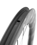 Close-up of Carbon Disc Wheelset S All D28 50 Tubeless With Carbon Spokes 700C rim detailing for ultralight and quick acceleration on road bikes.