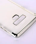 Close-up of a sleek metallic phone case with cutouts for camera and buttons, shown from the back angle with a shiny finish.