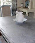 Kickass Water Based Wood Stain With A Slick Gray Brown Tint on a smooth tabletop, showcasing a weathered driftwood look.