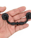 Hand holding a Six Pcs Vintage Black Drawer Pulls Handles Metal Bail Pulls for Cabinets in classic antique style, shown in detail.