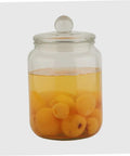 Level Up Your Pantry Setup With These Hella Tough 2 Liter Airtight Glass Tea Canisters And Food Storage Jar Set Built To Seal In Freshness For Coffee Beans Snacks And Grains While Keeping Counter Space Clean: Glass canister filled with yellow apricots in liquid.