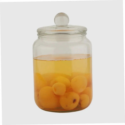 Level Up Your Pantry Setup With These Hella Tough 2 Liter Airtight Glass Tea Canisters And Food Storage Jar Set Built To Seal In Freshness For Coffee Beans Snacks And Grains While Keeping Counter Space Clean: Glass canister filled with yellow apricots in liquid.