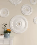 24 Inch Ceiling Medallion, 3 5/8 Inch Inner Opening, 1 1/4 Inch Projection, Lightweight And Factory Primed For Easy Install, displayed on wall