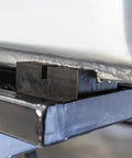 Close-up of 4Pcs Universal Jack Bracket Pads With Slot Design Pinch Weld Blocks For Car Chassis Protection, heavy-duty steel adapter under car.