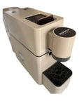 Image of the Slick Super Automatic Espresso Coffee Machine With Integrated Capsule System and Compact Pump Design, beige color, top view showing brewing compartment and drip tray.