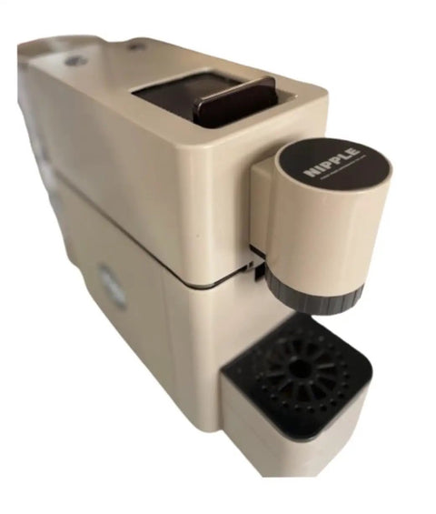 Image of the Slick Super Automatic Espresso Coffee Machine With Integrated Capsule System and Compact Pump Design, beige color, top view showing brewing compartment and drip tray.