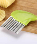 Front view of a green plastic-handle crinkle cutter with stainless-steel wavy blades for vegetables.