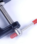 Close-up of Compact Mini Vise Clamp With A Rock Solid Hold for Woodworking, black finish and aluminum alloy screw mechanism.