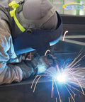 Side view of BETOOLL Argon Regulator for welding with 6.6ft gas hose; welder in protective gear