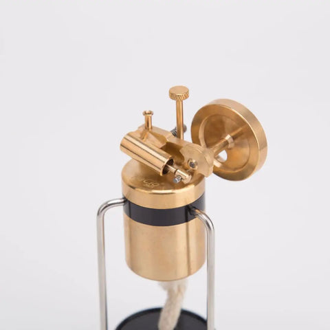 Close-up of Retro Three Legged Oscillating Steam Engine Model Kit For Hands On STEM Fun, brass gear meshing and piston action.