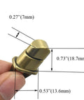Antique-brass purse turn lock held by fingers; metal handbag hardware, 1.1 inch length