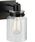 Close-up of Vintage Farmhouse Bath Vanity Light With Clear Glass Shades, 4 Light Antique Bronze Finish, Warm Mid Century Modern Vibe
