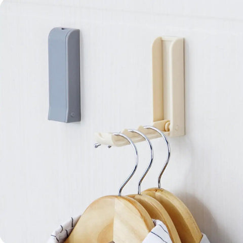 Slick Foldable Wall Hooks With Adhesive Backing For Space Saving No Drill Setup To Hang Jackets Purses Hats Or Dog Leashes In Foyer Closet Easy Install Design Works As A Lifesaver To Keep Home Clutter Free Always Two Pack gray and beige hooks with wooden hangers.