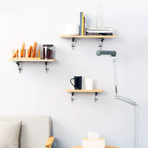 Heavy Duty Folding Triangle Brackets For Shelves holding wooden shelves with books, jars, and mugs in a modern living room.
