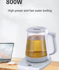 2 Liter Multifunctional Electric Kettle And Coffee Pot With Built In Strainer Stewing Cup Health Focused Water Boiler Top Tier Kitchen Essential Smooth Operator For Daily Brewing And No Stress Cooking on wooden table with laptop.