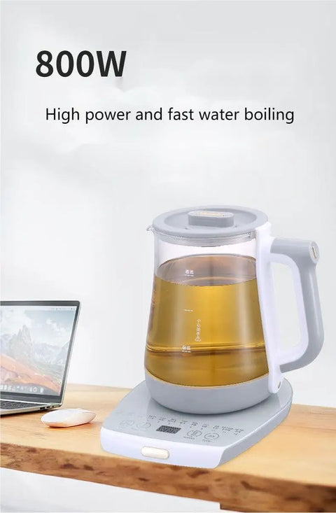 2 Liter Multifunctional Electric Kettle And Coffee Pot With Built In Strainer Stewing Cup Health Focused Water Boiler Top Tier Kitchen Essential Smooth Operator For Daily Brewing And No Stress Cooking on wooden table with laptop.