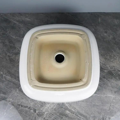Top view of the USZWBY Vessel Sinks Bathroom Vessel Sink Household Small Space Ceramic Wash Basin with round drain hole.