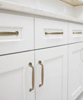 Antique Brass Cabinet Pulls 10 Pack Center To Center 5 Inch Vintage Kitchen Cabinet Handles installed on white drawers