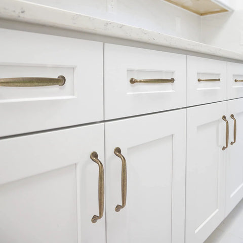 Antique Brass Cabinet Pulls 10 Pack Center To Center 5 Inch Vintage Kitchen Cabinet Handles installed on white drawers