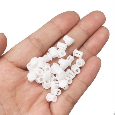 Hand holding Plastic 3/16 Inch Flush Hole Plugs With Snap In Locking Design Conceal Nail Holes Shelf And Cabinet Holes White Pack Of 100