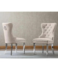 Super Sleek White Marble Round Dining Set With Four Plush Cream Velvet Chairs And No Hassle Lazy Susan Top Featuring Rugged Silver Stainless Steel Base. Two plush cream velvet chairs with tufted backs and silver legs.