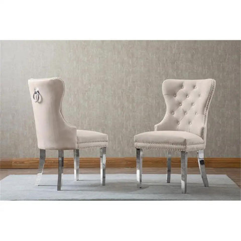 Super Sleek White Marble Round Dining Set With Four Plush Cream Velvet Chairs And No Hassle Lazy Susan Top Featuring Rugged Silver Stainless Steel Base. Two plush cream velvet chairs with tufted backs and silver legs.