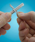 Close-up of hands holding a pin from a 74-Piece Zinc-Plated Clevis Pin Set With Assorted Sizes For Mowers, Trailers, Gates And Handy DIY Projects
