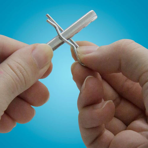Close-up of hands holding a pin from a 74-Piece Zinc-Plated Clevis Pin Set With Assorted Sizes For Mowers, Trailers, Gates And Handy DIY Projects