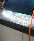 Portable Micro Hydroelectric Turbine Generator For DIY LED Lighting And Off Grid Power powering LED strip lights on a countertop