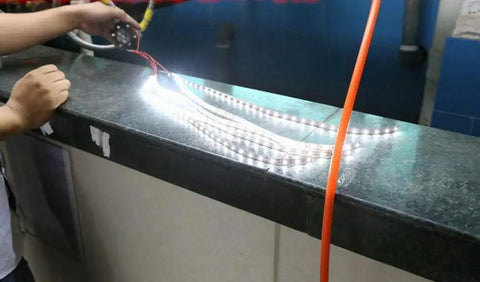 Portable Micro Hydroelectric Turbine Generator For DIY LED Lighting And Off Grid Power powering LED strip lights on a countertop