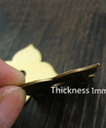 Close-up of 4 Pack Brass Drawer Pulls Antique Brass Cabinet Ring Handles showing 1mm thickness with fingers holding the edge