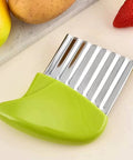 Crinkle-cutting tool with a green handle and stainless steel wavy blade for slicing vegetables