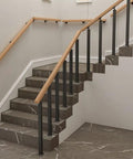 Heavy Duty Black Railing Balusters And Stair Spindles 25 Pack Wrought Iron Look Deck Post Kit with adjustable black balusters on a staircase.