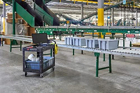 Two Shelf Foam Utility Cart With Lipped Shelves And Ergonomic Handle Black 500 Lb Capacity Durable Rolling Cart in a warehouse.
